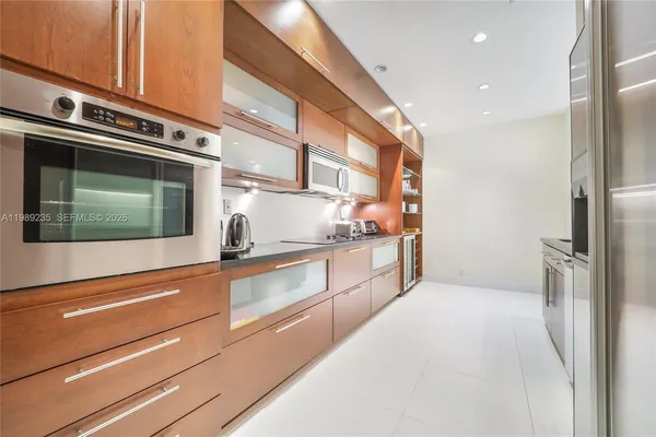 a kitchen with stainless steel appliances a refrigerator and a stove