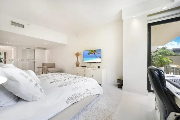 a bedroom with a bed and a chair