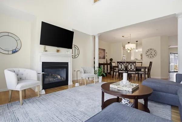 a living room with furniture a flat screen tv and a fireplace