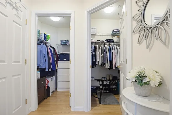 a view of walk in closet with clothes and shoes