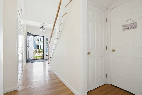 a view of a hallway with wooden floor and staircase