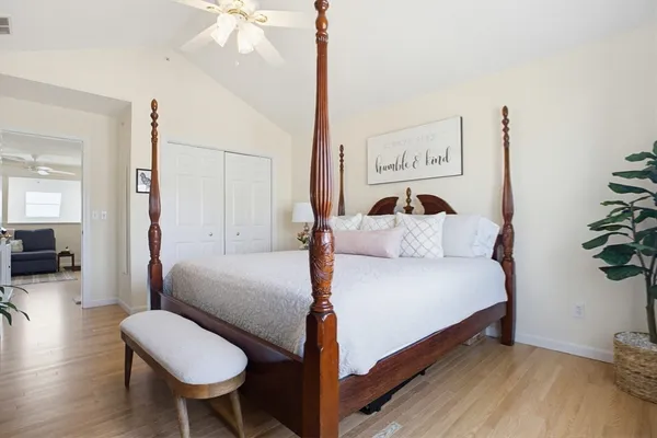 a bedroom with a bed and a chandelier