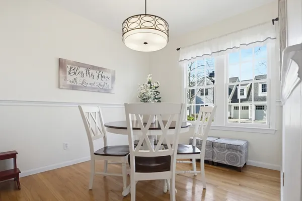 a dining room with furniture and wooden floor