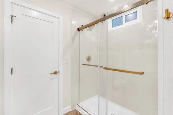 a bathroom with a shower and a glass door