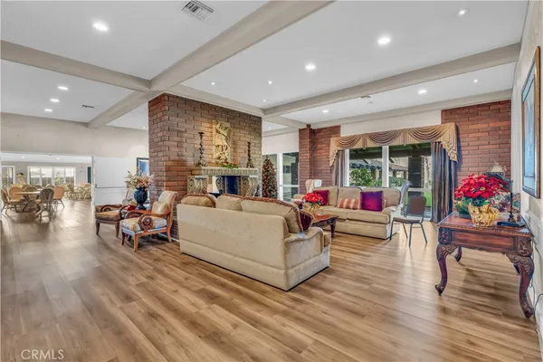 a view of a dining room with furniture wooden floor and a potted plant
