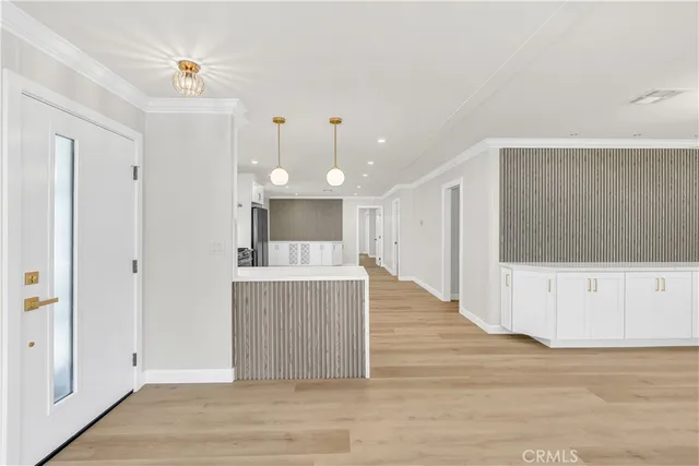 a view of kitchen with wooden floor and electronic appliances