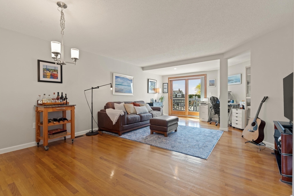 15 Flume Road, Unit 4 Gloucester, MA 01930 - Photo 12 of 41 a bedroom with furniture and a wooden floor