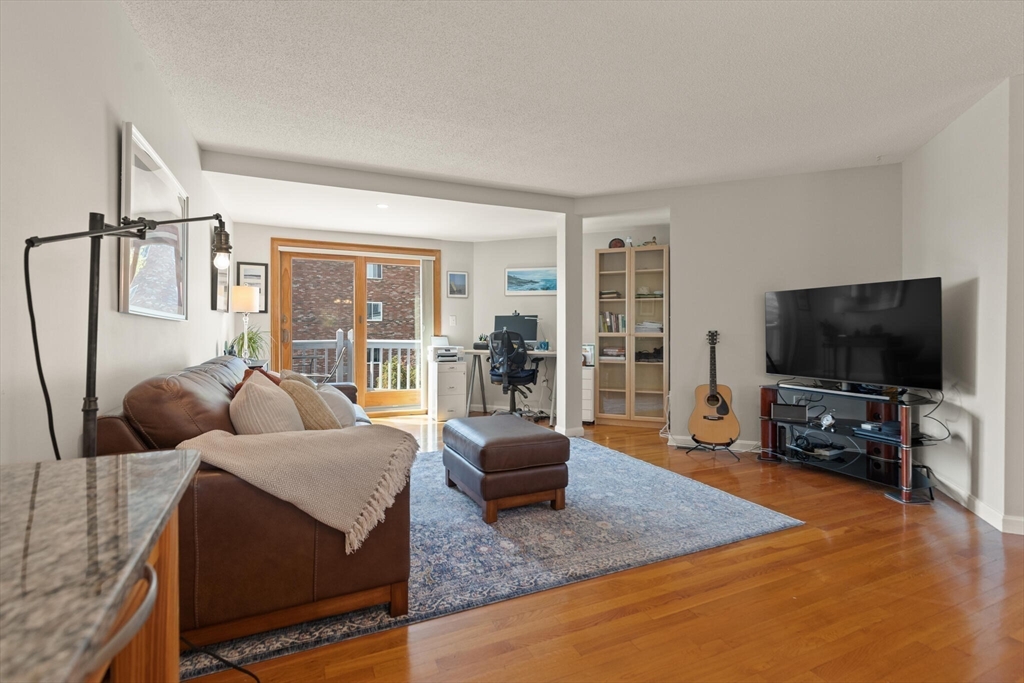 15 Flume Road, Unit 4 Gloucester, MA 01930 - Photo 15 of 41 a living room with furniture and a flat screen tv