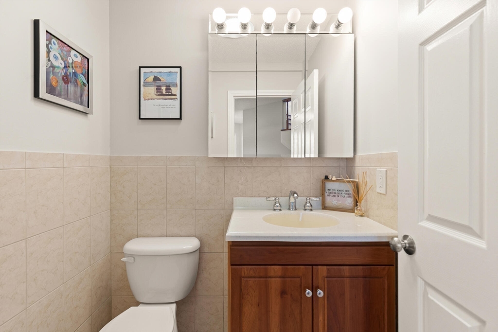 15 Flume Road, Unit 4 Gloucester, MA 01930 - Photo 16 of 41 a bathroom with a toilet sink and mirror