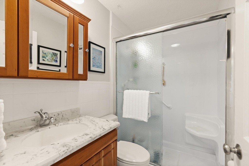 15 Flume Road, Unit 4 Gloucester, MA 01930 - Photo 24 of 41 a bathroom with a granite countertop sink toilet and shower