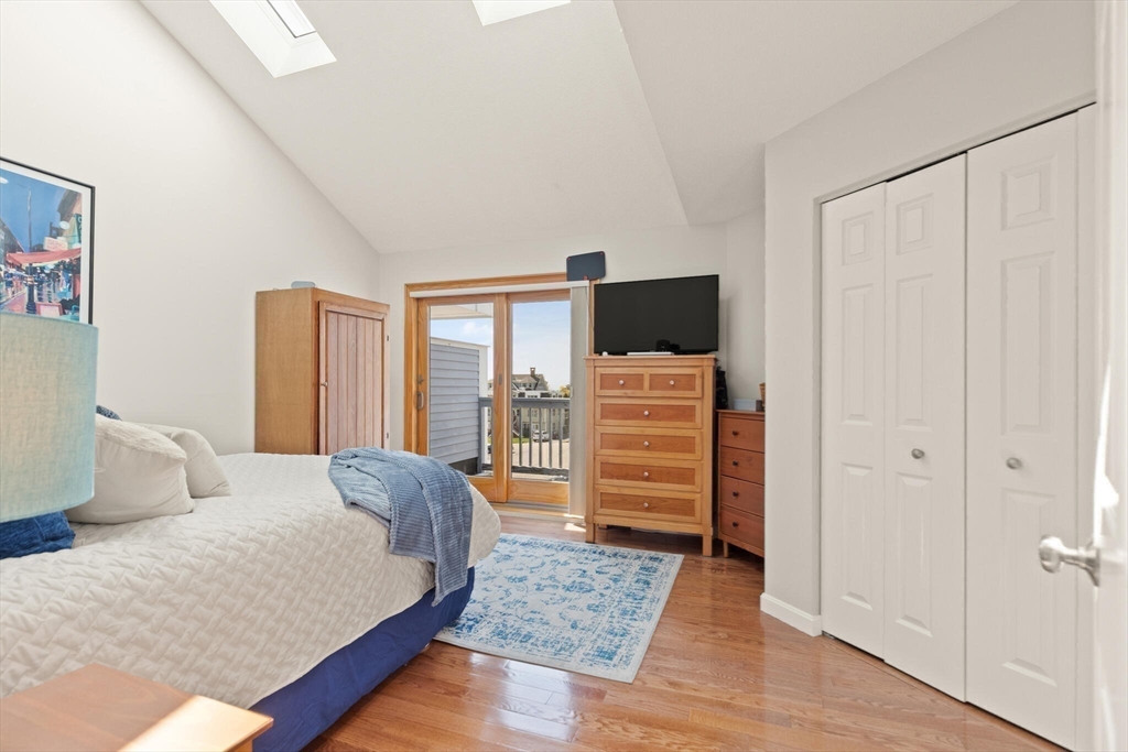 15 Flume Road, Unit 4 Gloucester, MA 01930 - Photo 25 of 41 a bedroom with a bed and wooden floor