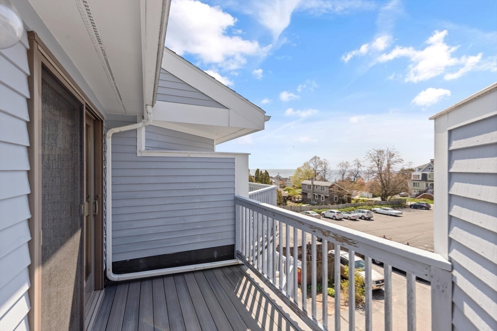 15 Flume Road, Unit 4 Gloucester, MA 01930 - Photo 26 of 41 a view of a balcony with wooden floor and fence