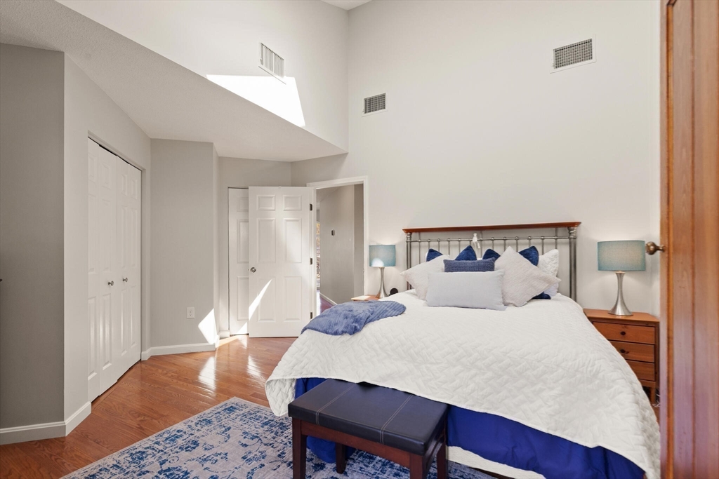 15 Flume Road, Unit 4 Gloucester, MA 01930 - Photo 29 of 41 a bedroom with a bed and wooden floor