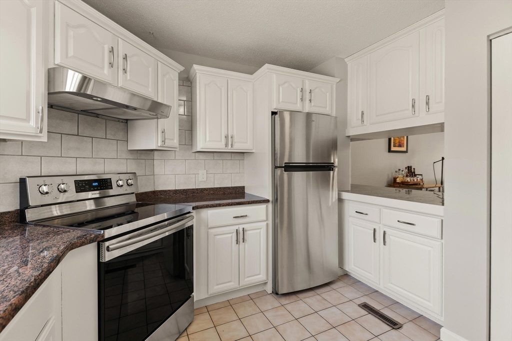 15 Flume Road, Unit 4 Gloucester, MA 01930 - Photo 9 of 41 a kitchen with cabinets stainless steel appliances and sink
