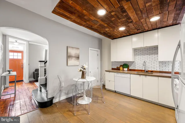 a large white kitchen with a large window