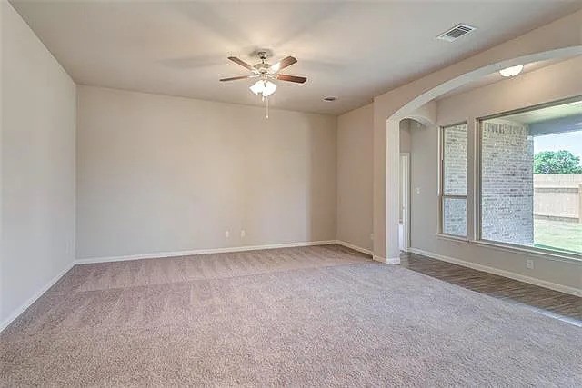 20008 Navarre Terrace Pflugerville, TX 78660 - Photo 7 of 18 an empty room with windows and chandelier fan
