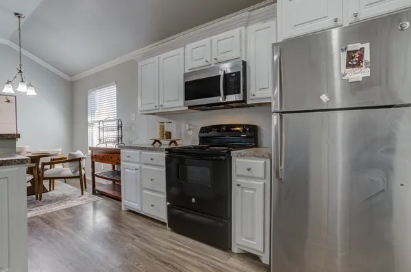 a kitchen with stainless steel appliances a refrigerator stove and microwave