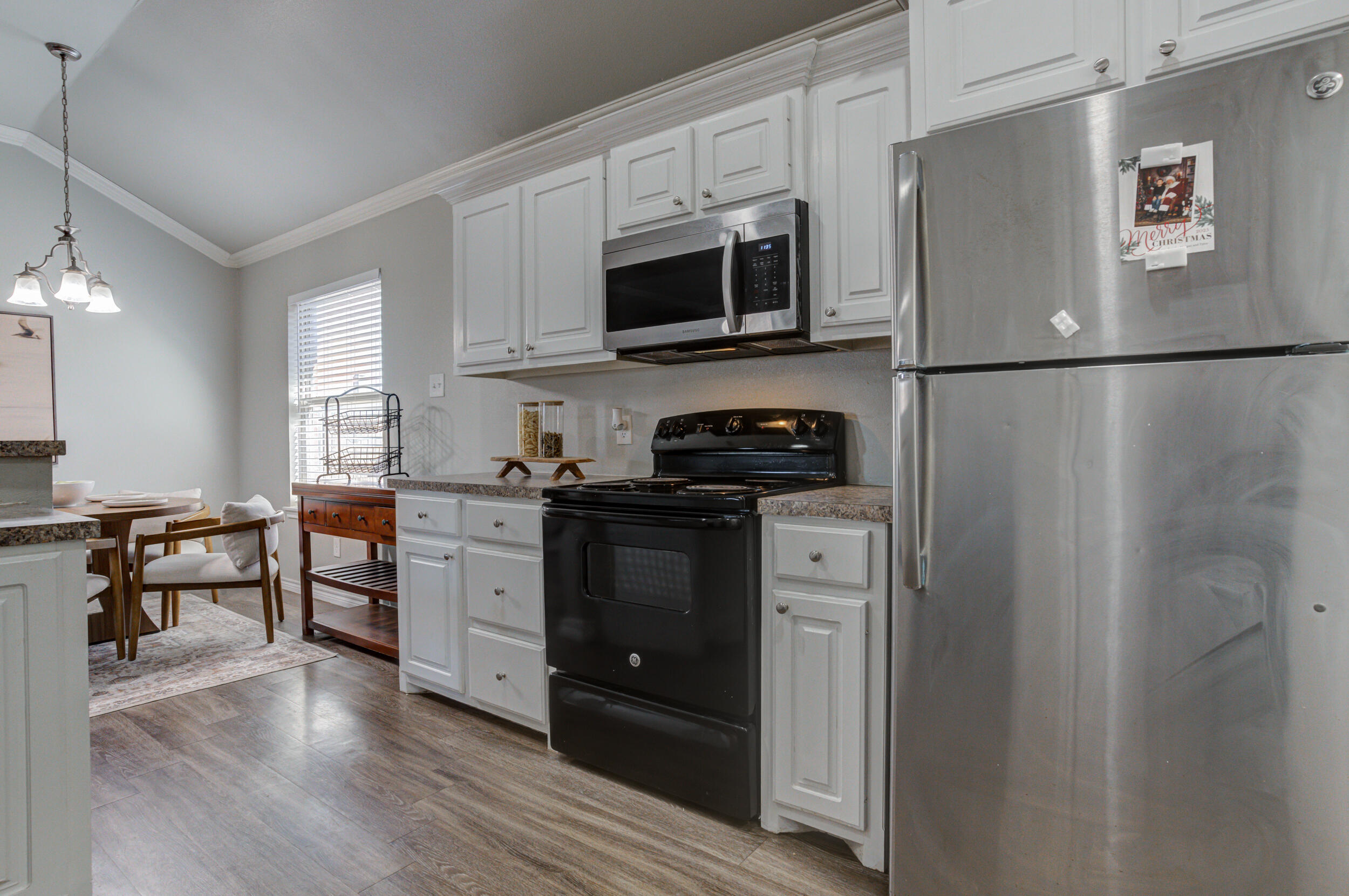 2022 88th Street Lubbock, TX 79423 - Photo 12 of 33 a kitchen with stainless steel appliances a refrigerator stove and microwave