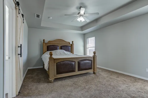 a bedroom with a bed and a chandelier