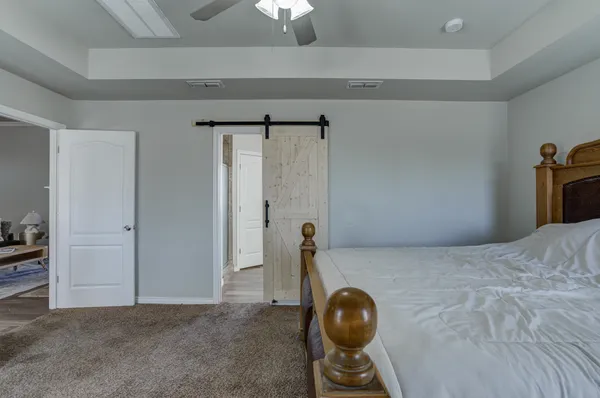 a bedroom with a bed and a chandelier