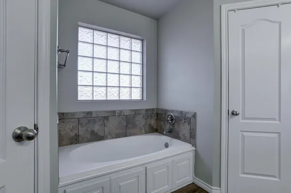 a white bath tub sitting next to a window