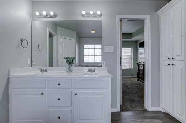 a bathroom with a double vanity sink and a mirror