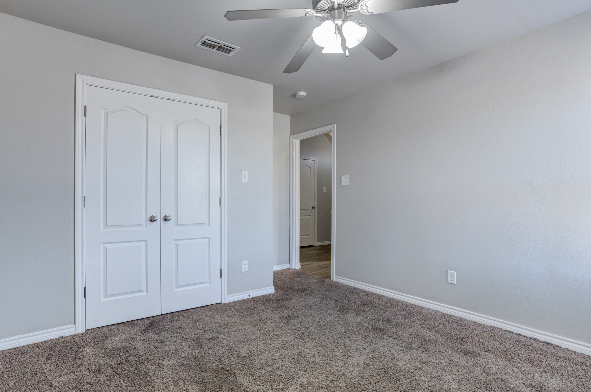 2022 88th Street Lubbock, TX 79423 - Photo 22 of 33 an empty room with a chandelier fan
