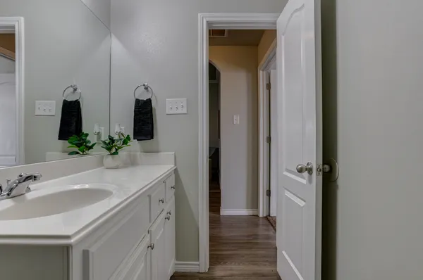 a bathroom with double vanity sink and a mirror