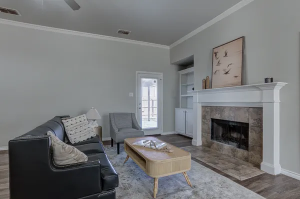 a living room with furniture and a fireplace