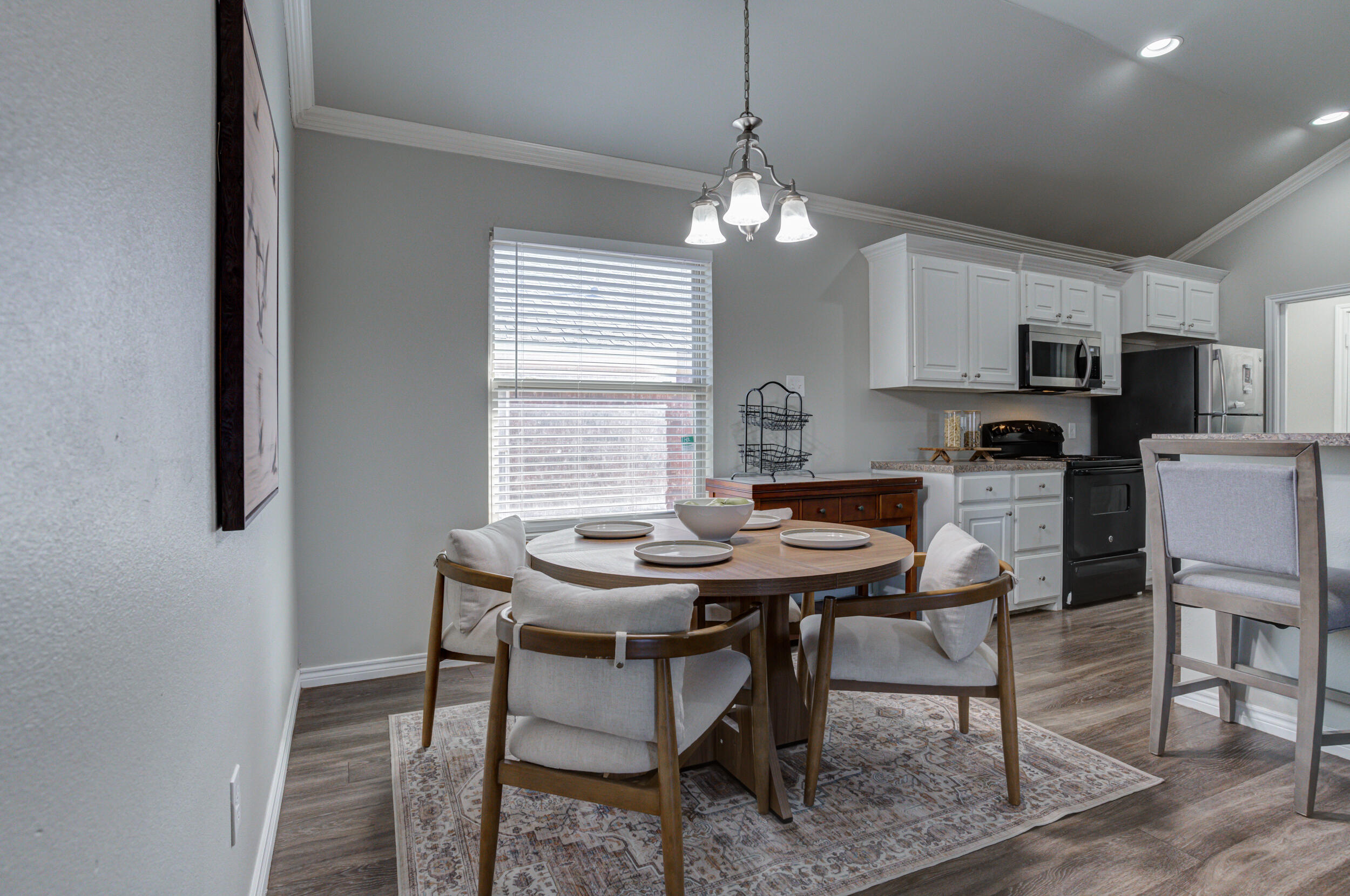 2022 88th Street Lubbock, TX 79423 - Photo 7 of 33 a view of a dining room with furniture window and wooden floor