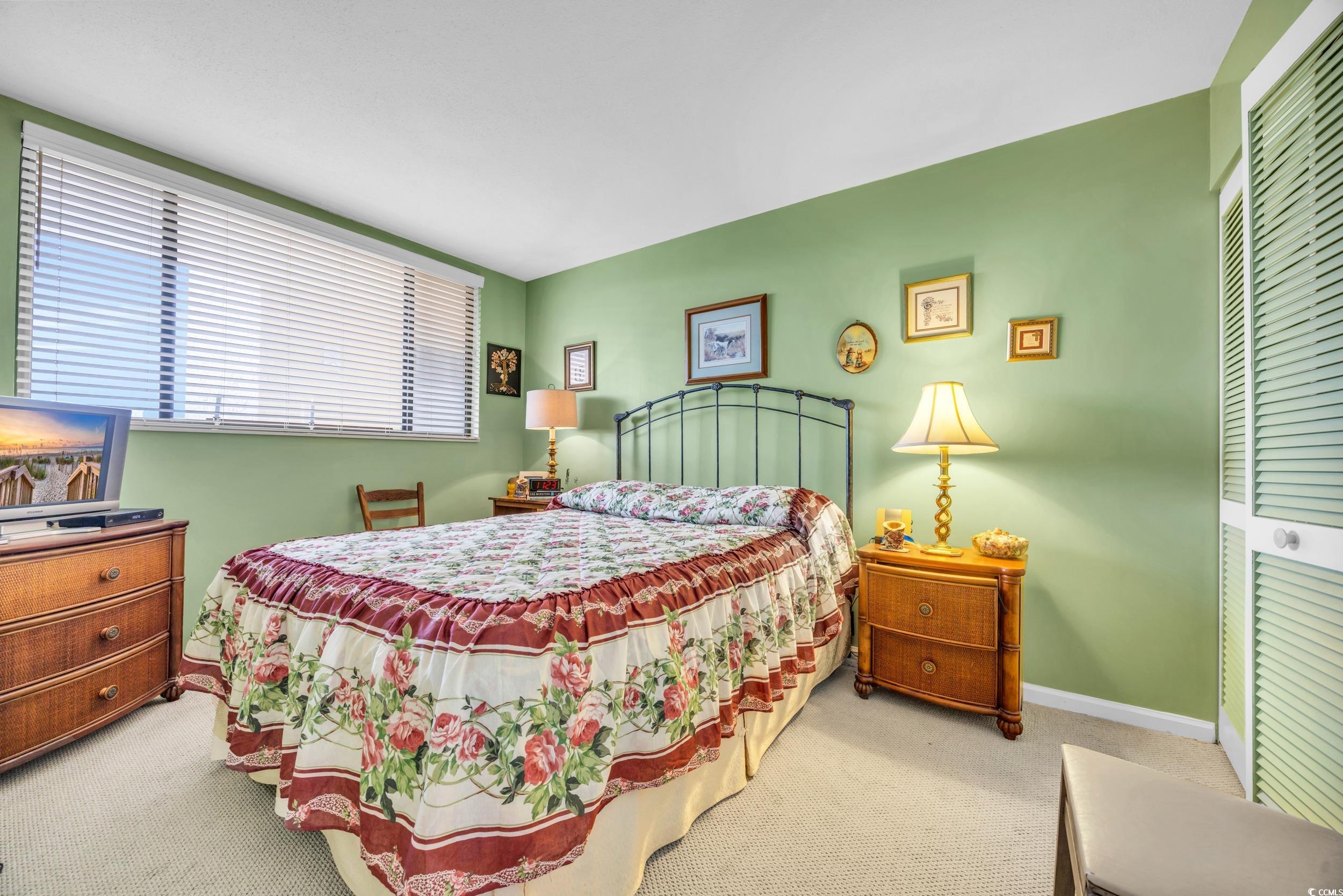 310 73rd Avenue North, Unit 5C Myrtle Beach, SC 29572 - Photo 13 of 20 Carpeted bedroom featuring a closet and baseboards