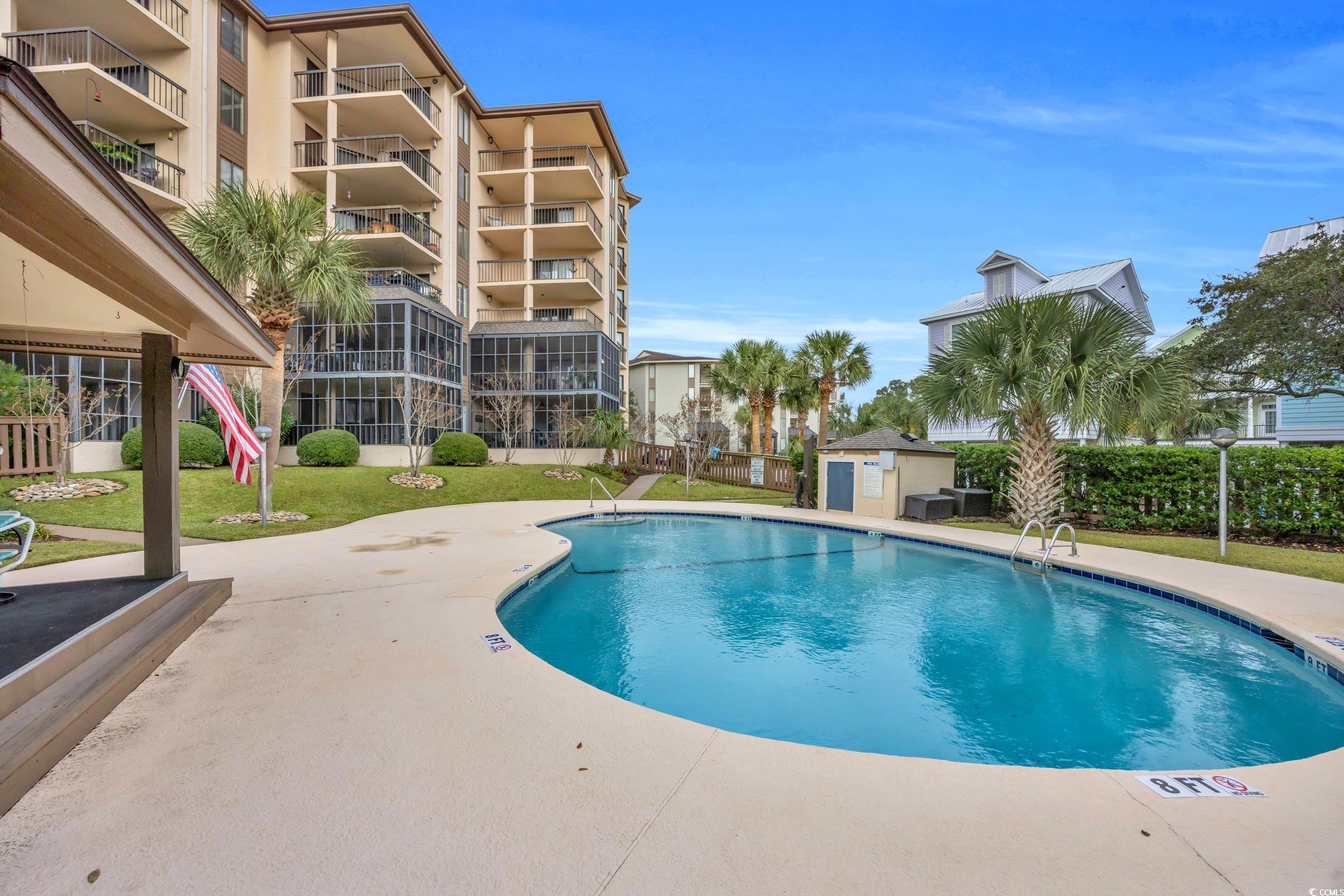 310 73rd Avenue North, Unit 5C Myrtle Beach, SC 29572 - Photo 2 of 20 Community pool featuring a patio