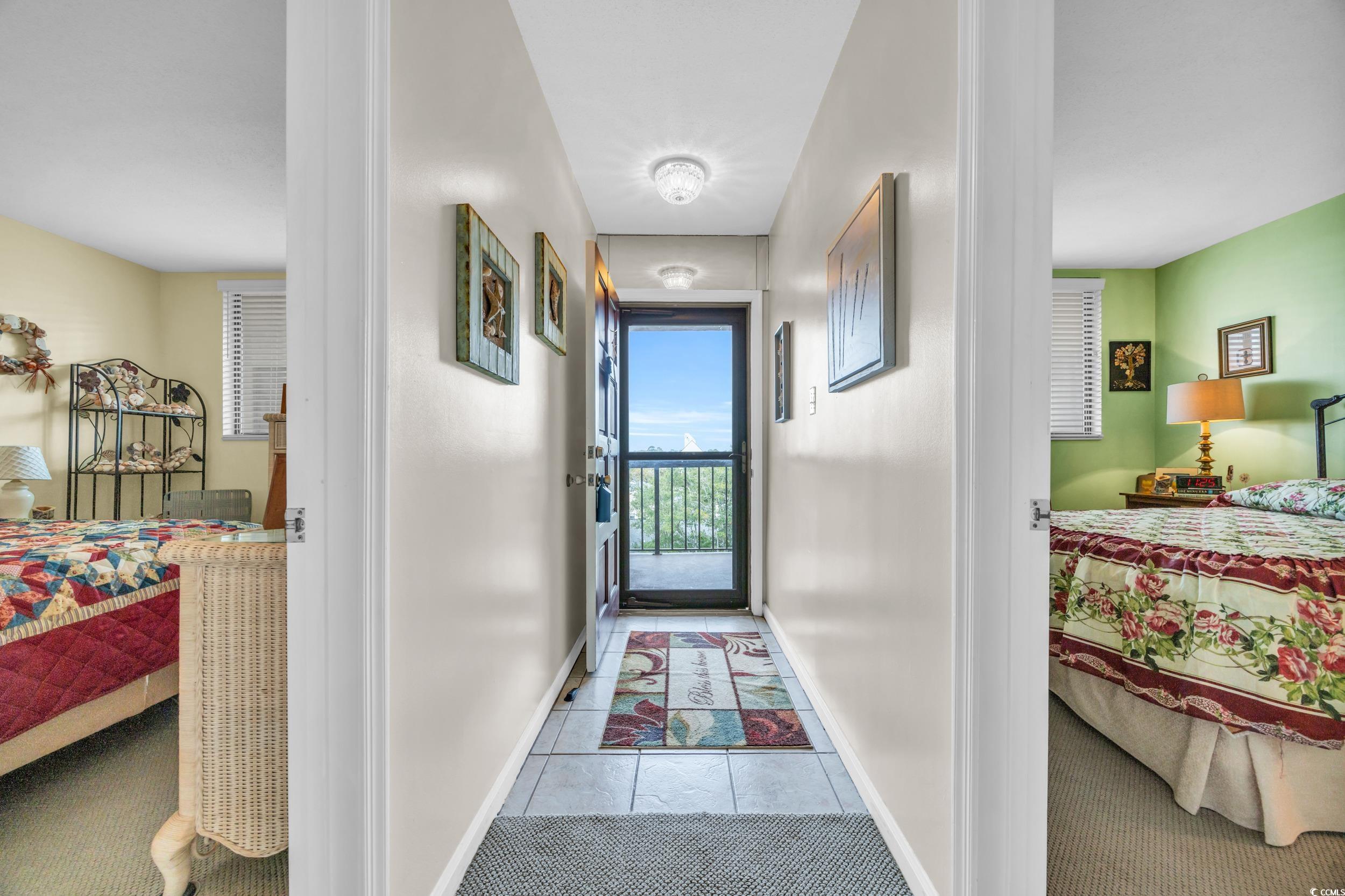 310 73rd Avenue North, Unit 5C Myrtle Beach, SC 29572 - Photo 4 of 20 Corridor featuring tile patterned floors and baseboards