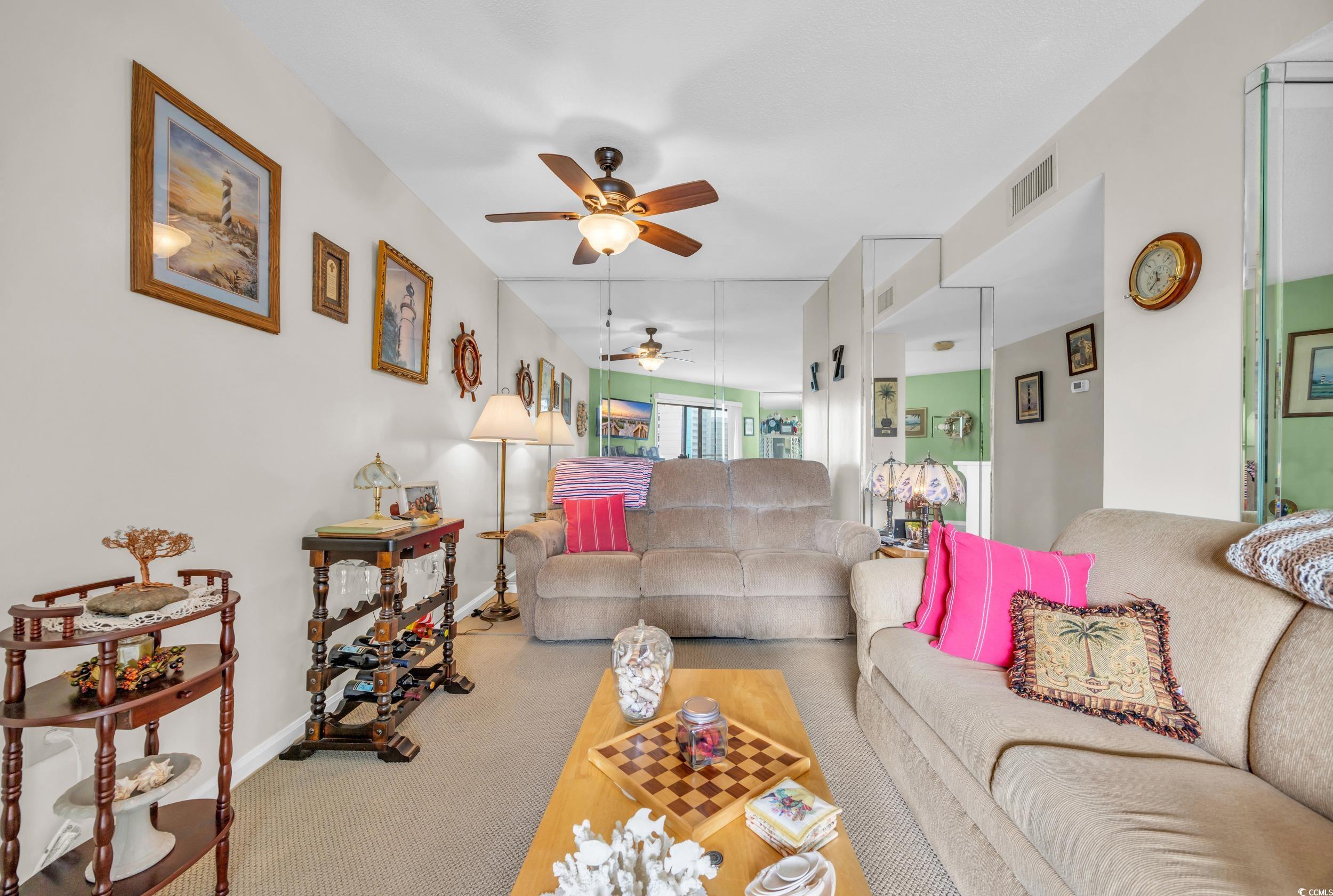 310 73rd Avenue North, Unit 5C Myrtle Beach, SC 29572 - Photo 5 of 20 Carpeted living room featuring ceiling fan and baseboards