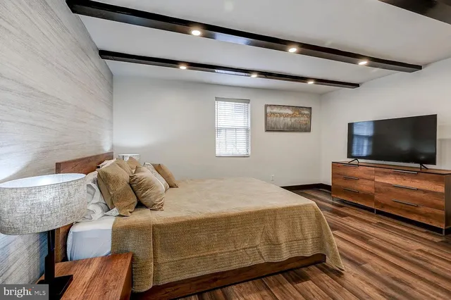 a bedroom with a bed and flat screen tv