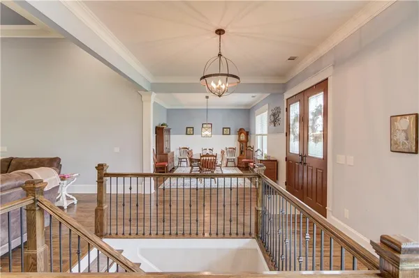 a large kitchen with granite countertop lots of counter space and wooden floor