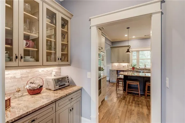 a kitchen with stainless steel appliances granite countertop a stove refrigerator and cabinets