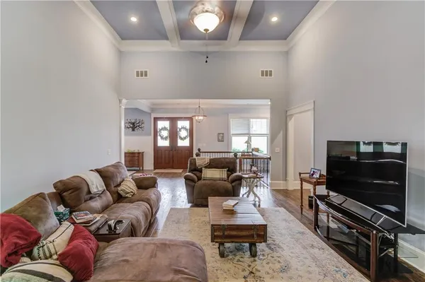 a spacious bedroom with a bed chandelier and a window