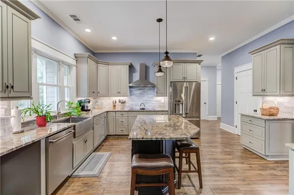 a en suite bathroom with a granite countertop sink and a mirror