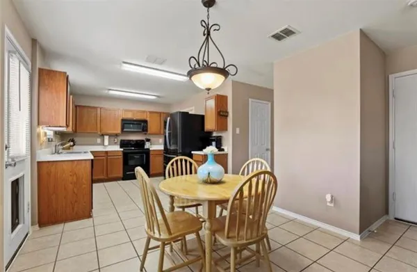 a dining room with furniture and chandelier