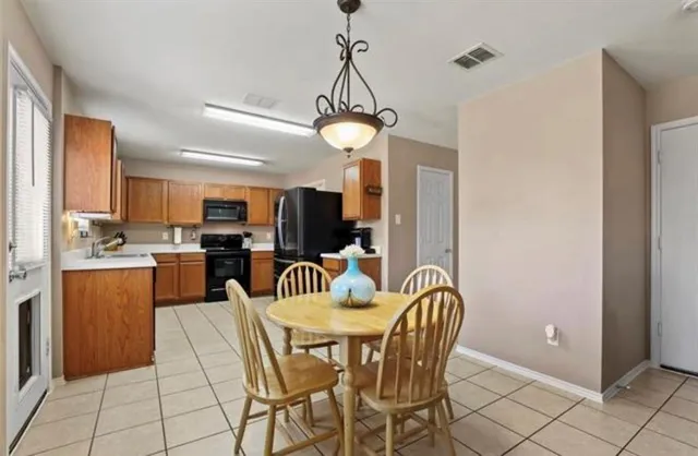 a dining room with furniture and chandelier