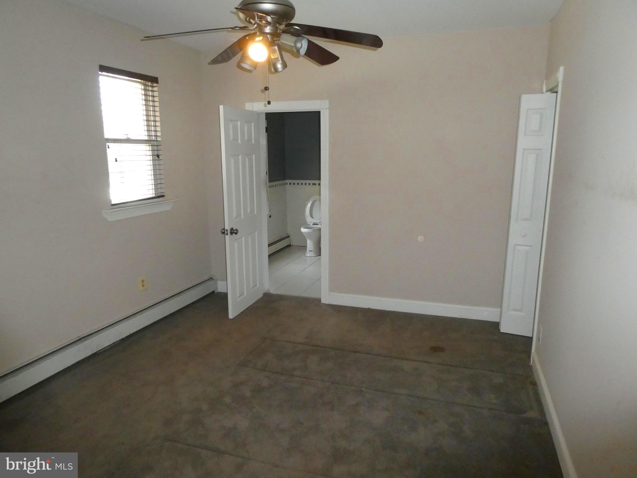 2024 Elm Avenue Atco, NJ 08004 - Photo 7 of 25 en empty room with windows and chandelier fan