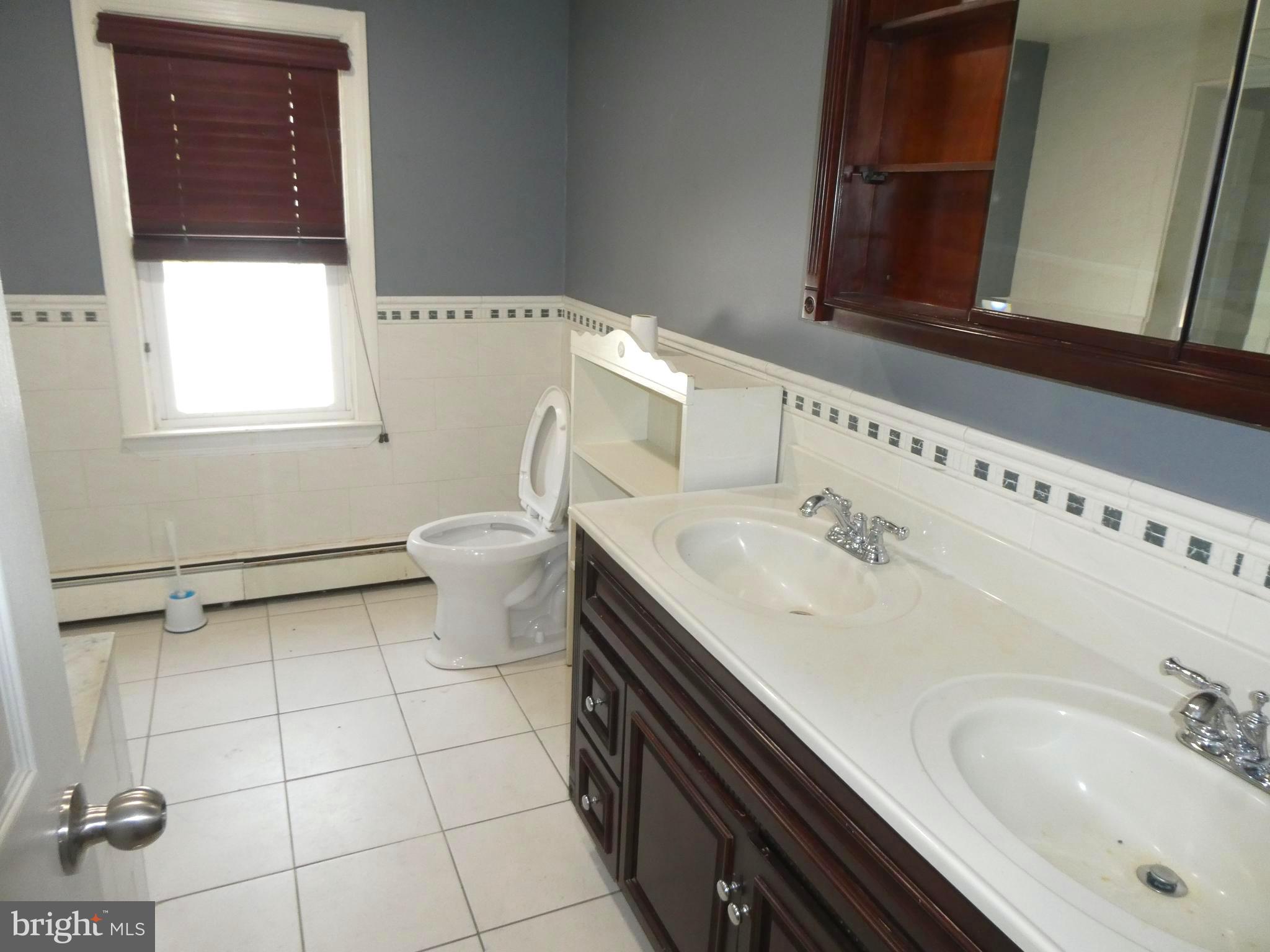 2024 Elm Avenue Atco, NJ 08004 - Photo 9 of 25 a bathroom with a sink a toilet and mirror
