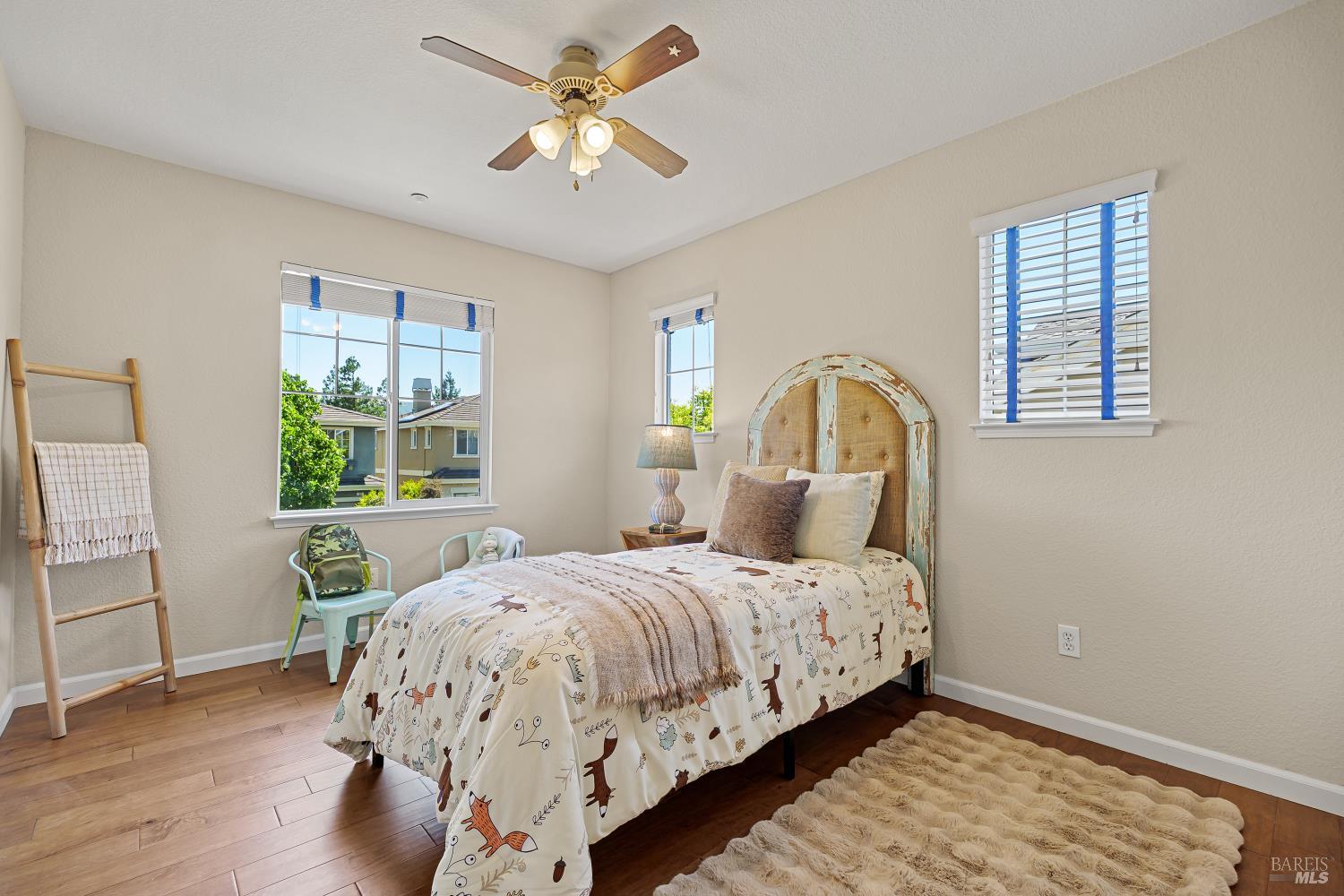 68 Pinheiro Circle Novato, CA 94945 - Photo 53 of 82 A bright and inviting secondary bedroom with large windows, ceiling fan, and plenty of natural light—perfect for family, guests, or a home office.