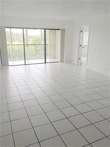 a view of an empty room and a window