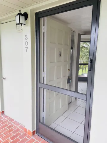 a view of a hallway with wooden floor and entryway