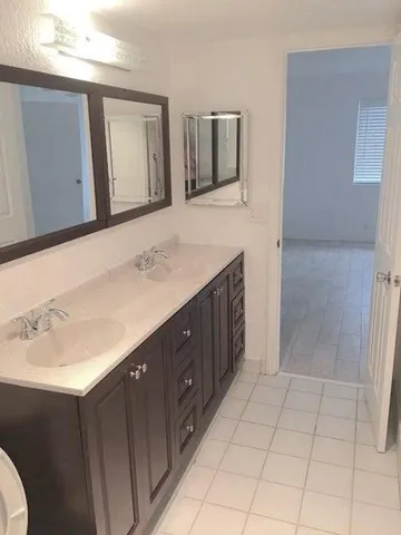 a bathroom with a sink a vanity and a mirror