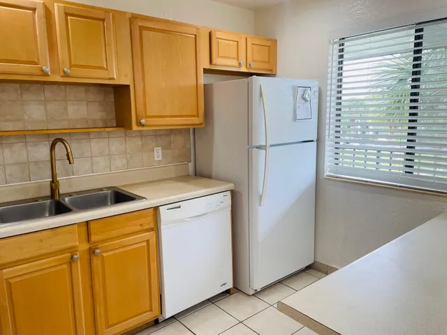 a white refrigerator freezer sitting in a kitchen
