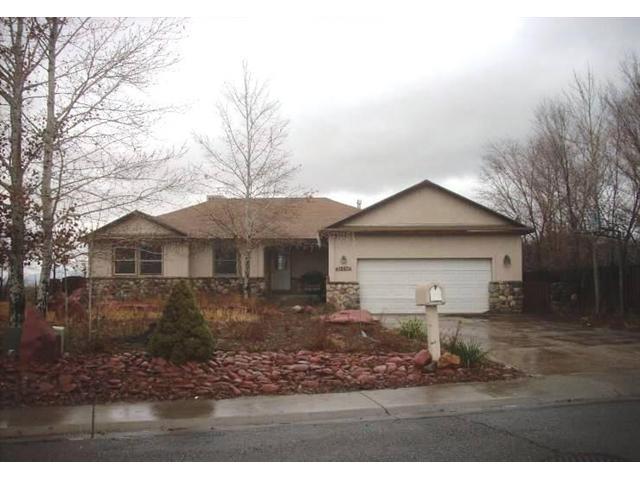 1347 Anvil View Avenue Rifle, CO 81650 - Photo 1 of 1 a view of a yard in front of a house with large trees