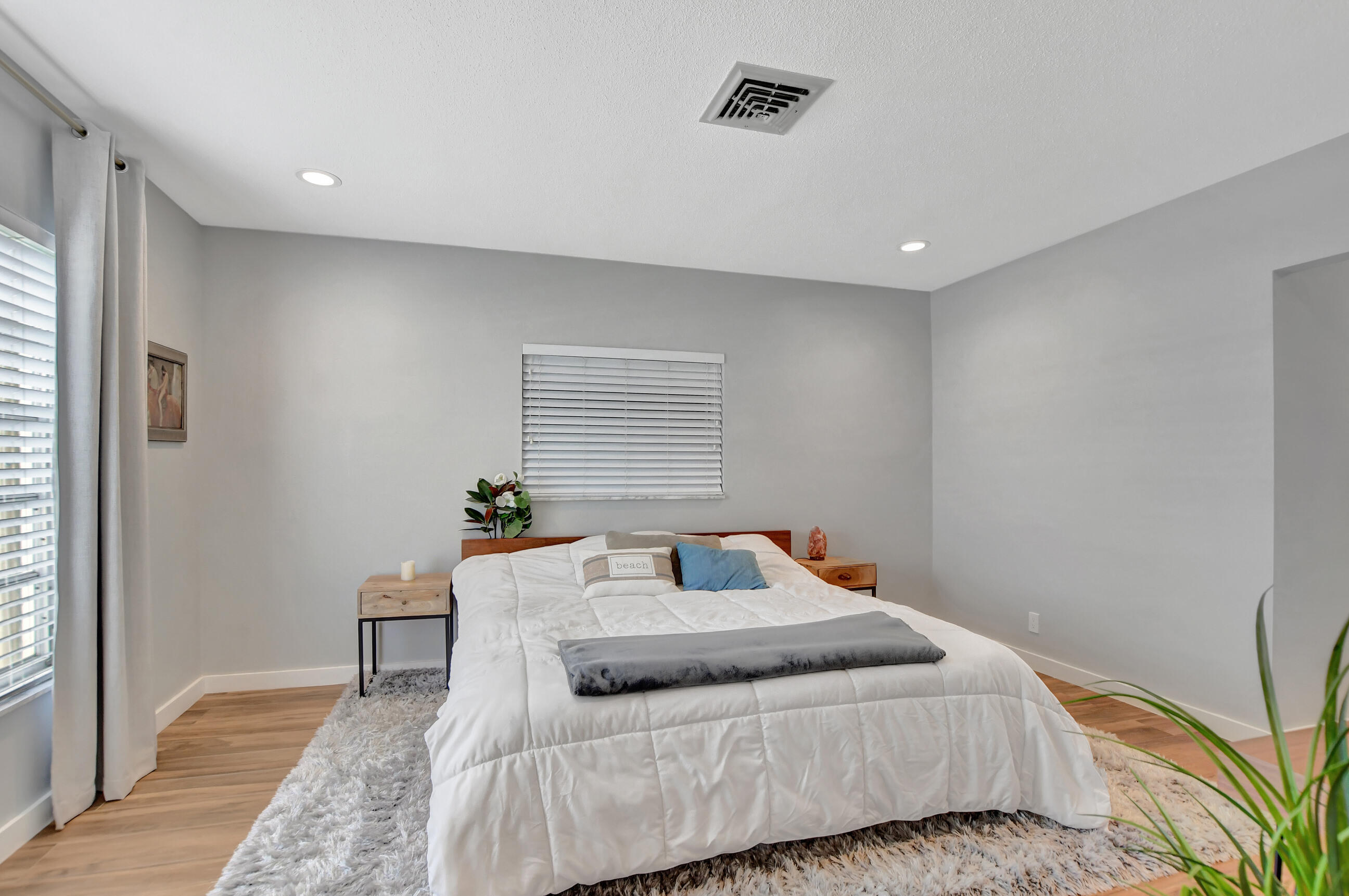 510 Silver Lane Boca Raton, FL 33432 - Photo 8 of 24 a bedroom with a bed and wooden floor